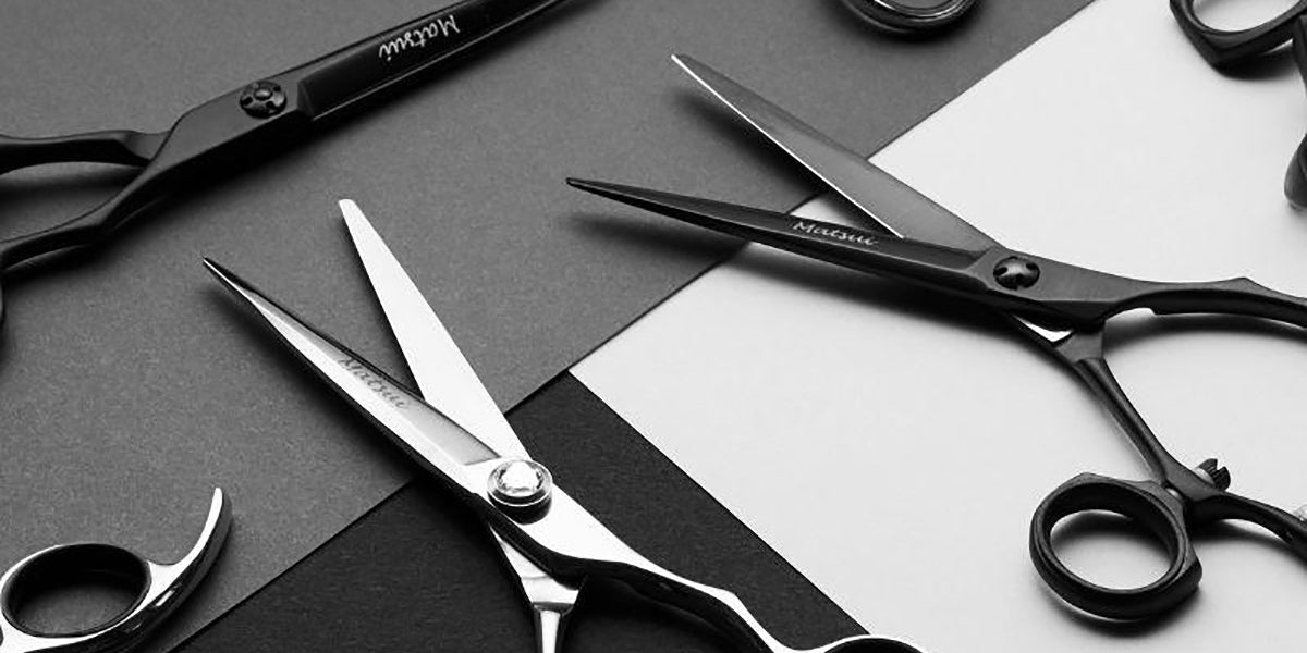 Black and silver scissors with black grey and white background